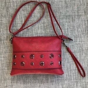 Red Crossbody convertible wristlet bag with metal eyelets
